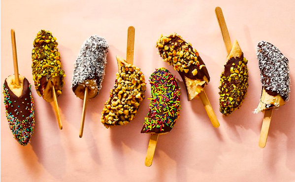 Assorted chocolate dipped bananas with toppings
